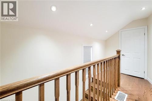 Upper landing featuring wood-finish flooring, a wood baluster railing, and recessed ceiling lighting - 319 King Street W, Dundas, ON - Indoor Photo Showing Other Room