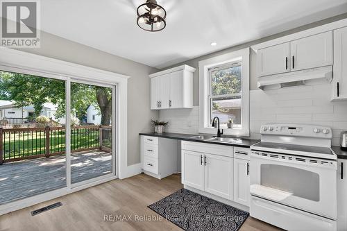 walk out to back deck - 185 Trafalgar Street, West Perth (Mitchell), ON - Indoor Photo Showing Kitchen With Double Sink