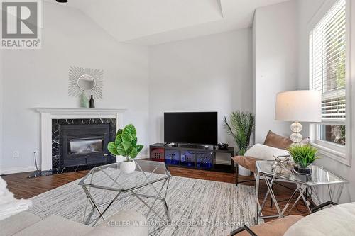 Bright 2nd-floor den w/ fireplace & large windows - 149 Cove Crescent, Hamilton, ON - Indoor Photo Showing Living Room With Fireplace