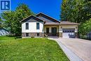 Modern home exterior featuring cream siding with dark gray shingle accents and a stone veneer foundation - 514 Fishers Glen Road, Vittoria, ON  - Outdoor With Facade 