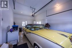 Spacious garage featuring white walls and a light concrete floor - 