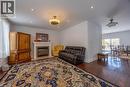 Living area featuring wood-finish flooring, a built-in fireplace with a stone surround, recessed lighting, and a ceiling fan - 514 Fishers Glen Road, Vittoria, ON  - Indoor Photo Showing Living Room With Fireplace 