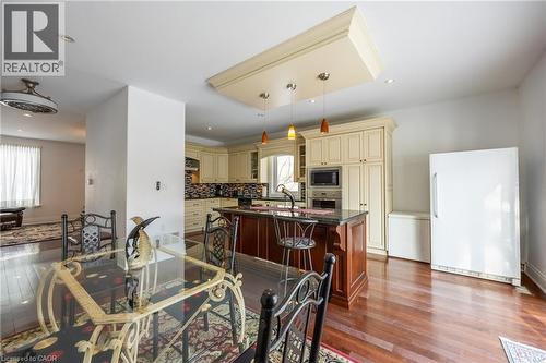Open-concept kitchen and dining area featuring rich wood-finish flooring - 514 Fishers Glen Road, Vittoria, ON - Indoor
