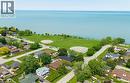 Property featuring a white-sided exterior, mature trees, and a spacious green lawn - 439 Murray Street, Grimsby, ON  - Outdoor With Body Of Water With View 
