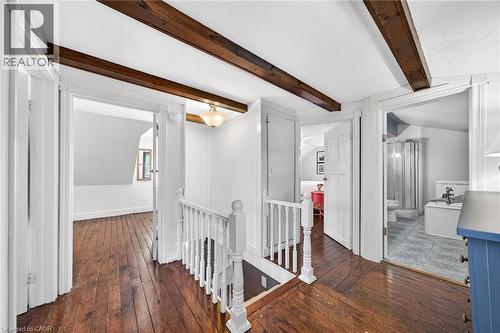 Upper-level hallway featuring exposed wood ceiling beams and rich wood-finish flooring - 439 Murray Street, Grimsby, ON - Indoor Photo Showing Other Room