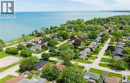 Aerial perspective showcasing a residential neighborhood with verdant trees and manicured lawns - 439 Murray Street, Grimsby, ON - Outdoor With Body Of Water With View
