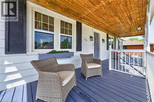 Covered front porch featuring a wood-finish ceiling, white baluster railing, and  plank flooring - 439 Murray Street, Grimsby, ON - Outdoor With Deck Patio Veranda With Exterior
