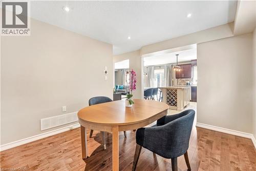 Dining area featuring wood-finish flooring, recessed lighting, and a neutral color palette - 21 Davinci Boulevard, Hamilton, ON - Indoor Photo Showing Dining Room