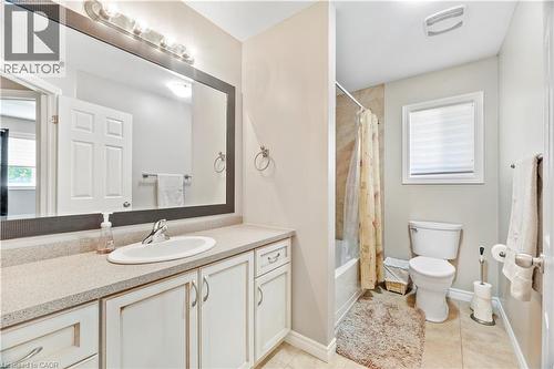 Bathroom featuring a single vanity with a white oval sink, light-colored countertop, and white cabinetry - 21 Davinci Boulevard, Hamilton, ON - Indoor Photo Showing Bathroom