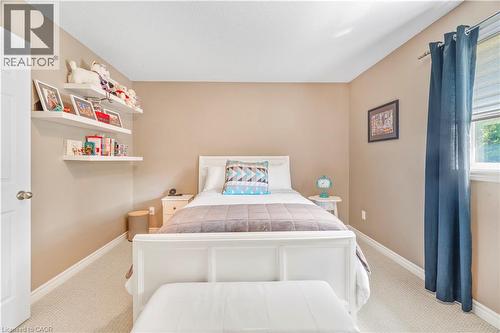 Neutral-toned room featuring light-colored carpeting, a window with window coverings, and white floating shelves - 21 Davinci Boulevard, Hamilton, ON - Indoor Photo Showing Bedroom