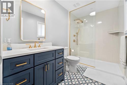 Built-in vanity with a white countertop and gold-tone fixtures - 21 Davinci Boulevard, Hamilton, ON - Indoor Photo Showing Bathroom