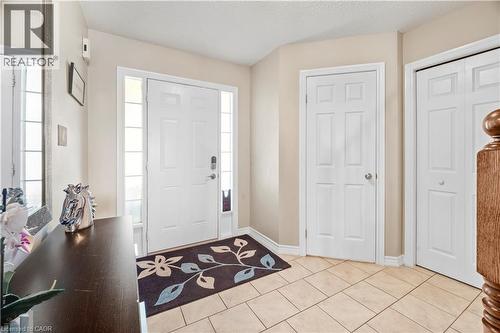 Entryway featuring a paneled front door with sidelight windows, tile flooring, and neutral wall tones - 21 Davinci Boulevard, Hamilton, ON - Indoor Photo Showing Other Room
