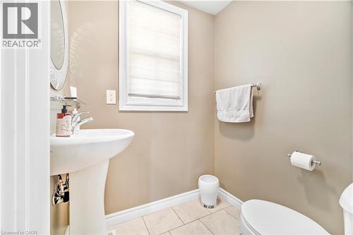 Pedestal sink with chrome faucet, complemented by a window with privacy blinds - 21 Davinci Boulevard, Hamilton, ON - Indoor Photo Showing Bathroom