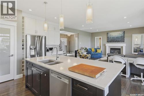 719 Salloum Crescent, Saskatoon, SK - Indoor Photo Showing Kitchen With Fireplace With Stainless Steel Kitchen With Double Sink With Upgraded Kitchen