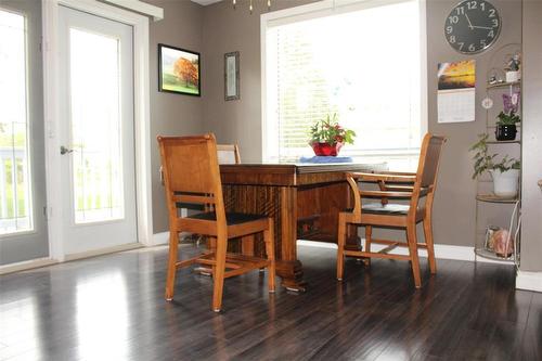 The dining area has a door out to the wrap around deck. - 387 William Street, Arborg, MB - Indoor Photo Showing Dining Room