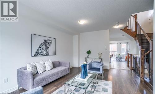 Main living area featuring dark wood-finish flooring, white walls, and recessed lighting - 14 Faye Street, Brampton, ON - Indoor Photo Showing Living Room