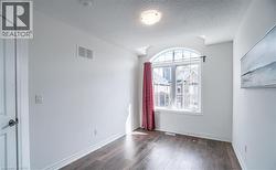 Arched window with gridded panes and a white frame - 