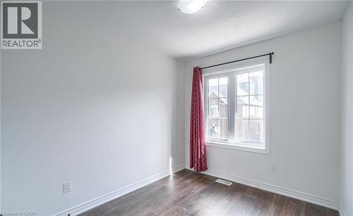Room featuring wood-finish flooring, white baseboards, and neutral wall paint - 14 Faye Street, Brampton, ON - Indoor Photo Showing Other Room
