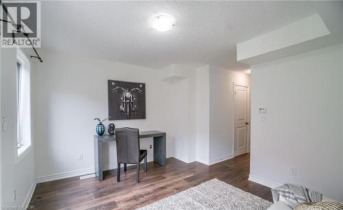 Interior room featuring wood-finish flooring, white walls, and a recessed ceiling light - 14 Faye Street, Brampton, ON - Indoor