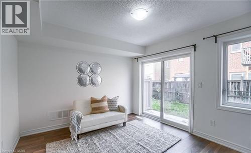 Patio door offering outdoor access, complemented by a large window - 14 Faye Street, Brampton, ON - Indoor