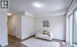 Bright interior featuring wood-finish flooring, white walls, and a sliding glass door - 