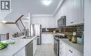 Bright kitchen featuring white cabinetry, stainless steel appliances, a subway tile backsplash, and light-toned countertops - 14 Faye Street, Brampton, ON  - Indoor Photo Showing Kitchen With Stainless Steel Kitchen With Double Sink With Upgraded Kitchen 