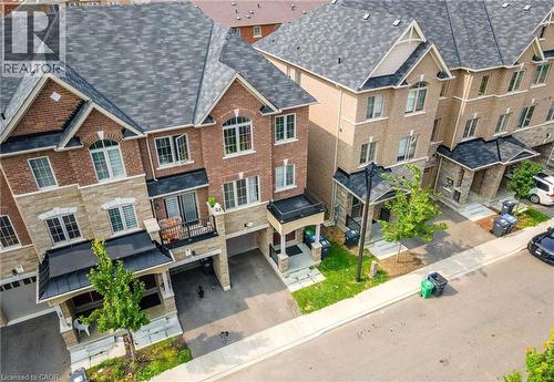 Brick and stone-clad townhomes featuring architectural shingles, covered entryways, and integral garages - 14 Faye Street, Brampton, ON - Outdoor With Facade