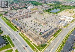 Aerial perspective showcasing a commercial plaza with extensive surface parking - 