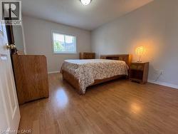 2nd Bedroom featuring wood-finish flooring, a window with blinds, and light-toned wall paint - 