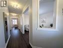 Hallway featuring dark wood-finish flooring, white baseboards, and contemporary ceiling light fixtures - 37 Mull Avenue, Caledonia, ON  - Indoor Photo Showing Other Room 