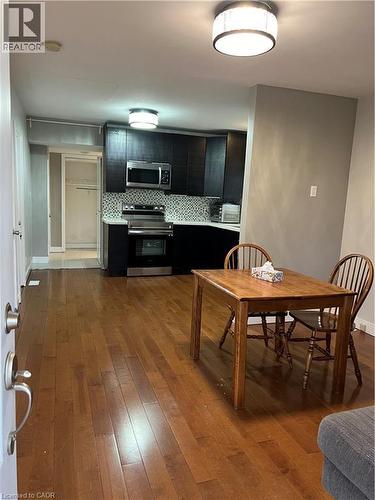 Open-concept living space with wood-finish flooring extending throughout - 179 S Vine Street S, St. Catharines, ON 