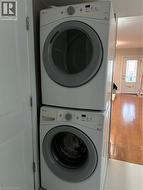 Stackable washer and dryer unit, featuring front-loading doors and integrated control panels - 