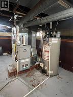 Utility area featuring a water heater and a furnace unit - 