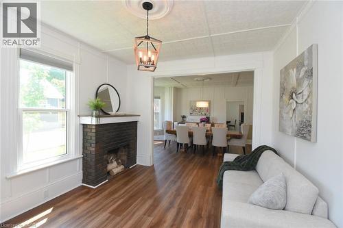 Living area featuring brick fireplace with a wood mantle - 89 Lynden Road, Lynden, ON 