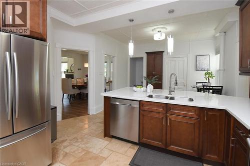 Kitchen with rich wood cabinetry, quartz countertops and stainless steel appliances - 89 Lynden Road, Lynden, ON 