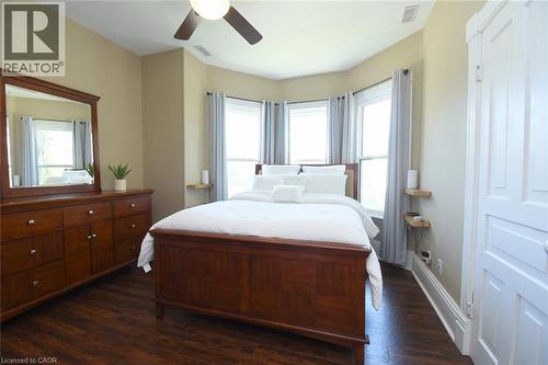 Spacious room featuring wood-finish flooring, a ceiling fan, and a three-panel bay window - 89 Lynden Road, Lynden, ON 