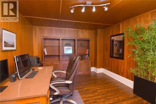 Room featuring wood-paneled walls, wood-finish flooring, shelving, white baseboards - 89 Lynden Road, Lynden, ON 
