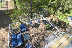 Elevated wood-finish deck with contemporary glass panel railings - 