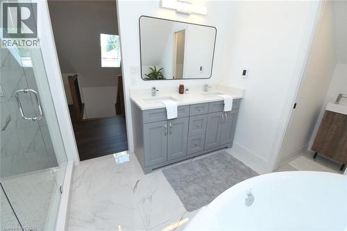 Contemporary bathroom featuring a dual vanity with light gray cabinetry, white countertops, and chrome fixtures - 89 Lynden Road, Lynden, ON 