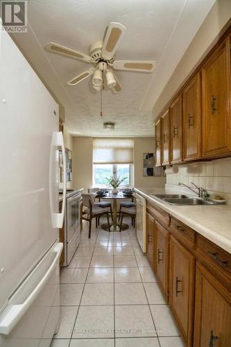 Galley kitchen Virtually Staged - 802 - 40 Harrisford Street, Hamilton, ON - Indoor Photo Showing Kitchen With Double Sink