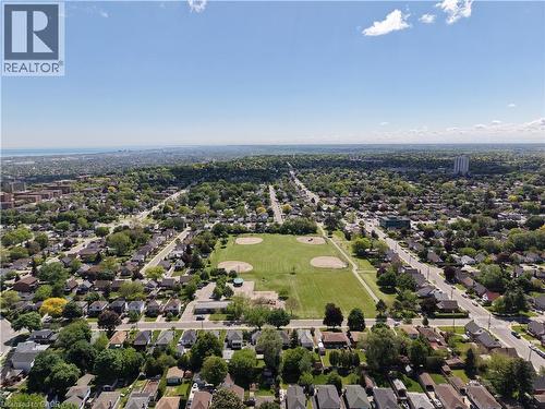 Aerial perspective of a residential area featuring a central green space with baseball diamonds - 92 East 24Th Street, Hamilton, ON - Outdoor With View