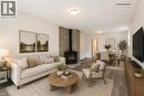 Virtually Staged LIVING & DINNING ROOM - 92 East 24Th Street, Hamilton, ON  - Indoor Photo Showing Living Room With Fireplace 