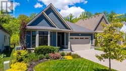 Front yard is landscaped under the bay window - 