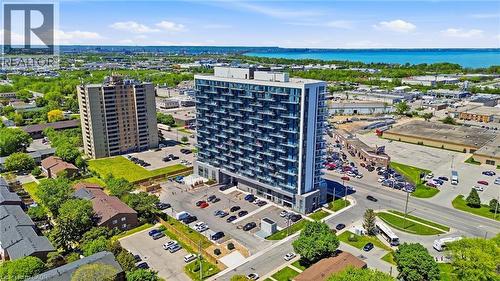 Modern high-rise building featuring extensive balconies, a multi-story exterior with varied finishes, and an on-site parking area - 2782 Barton Street E Unit# 516, Hamilton, ON - Outdoor With Body Of Water With View