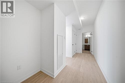 Hallway featuring light wood-finish flooring and bright white walls - 2782 Barton Street E Unit# 516, Hamilton, ON - Indoor Photo Showing Other Room