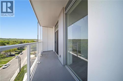 Private balcony featuring a clear glass and white metal railing, providing an open outdoor extension - 2782 Barton Street E Unit# 516, Hamilton, ON - Outdoor With Balcony With View With Exterior
