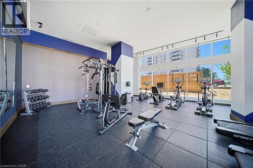 Fitness center featuring resilient flooring, full-height exterior windows, and track lighting - 2782 Barton Street E Unit# 516, Hamilton, ON - Indoor Photo Showing Gym Room