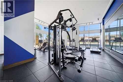 Dedicated fitness center featuring rubberized flooring, abundant natural light from expansive windows, track lighting, and a mirrored wall - 2782 Barton Street E Unit# 516, Hamilton, ON - Indoor Photo Showing Gym Room