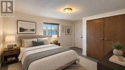 Lower level Bedroom (4) w/access to garage (staged - 