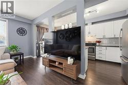 Open-concept living space featuring wood-finish flooring throughout - 
